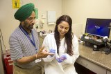 College of Sequoias student Serena Corrales learning from Microbiologist Randhawa at the Adventist Health/Community Care, Hanford lab.
